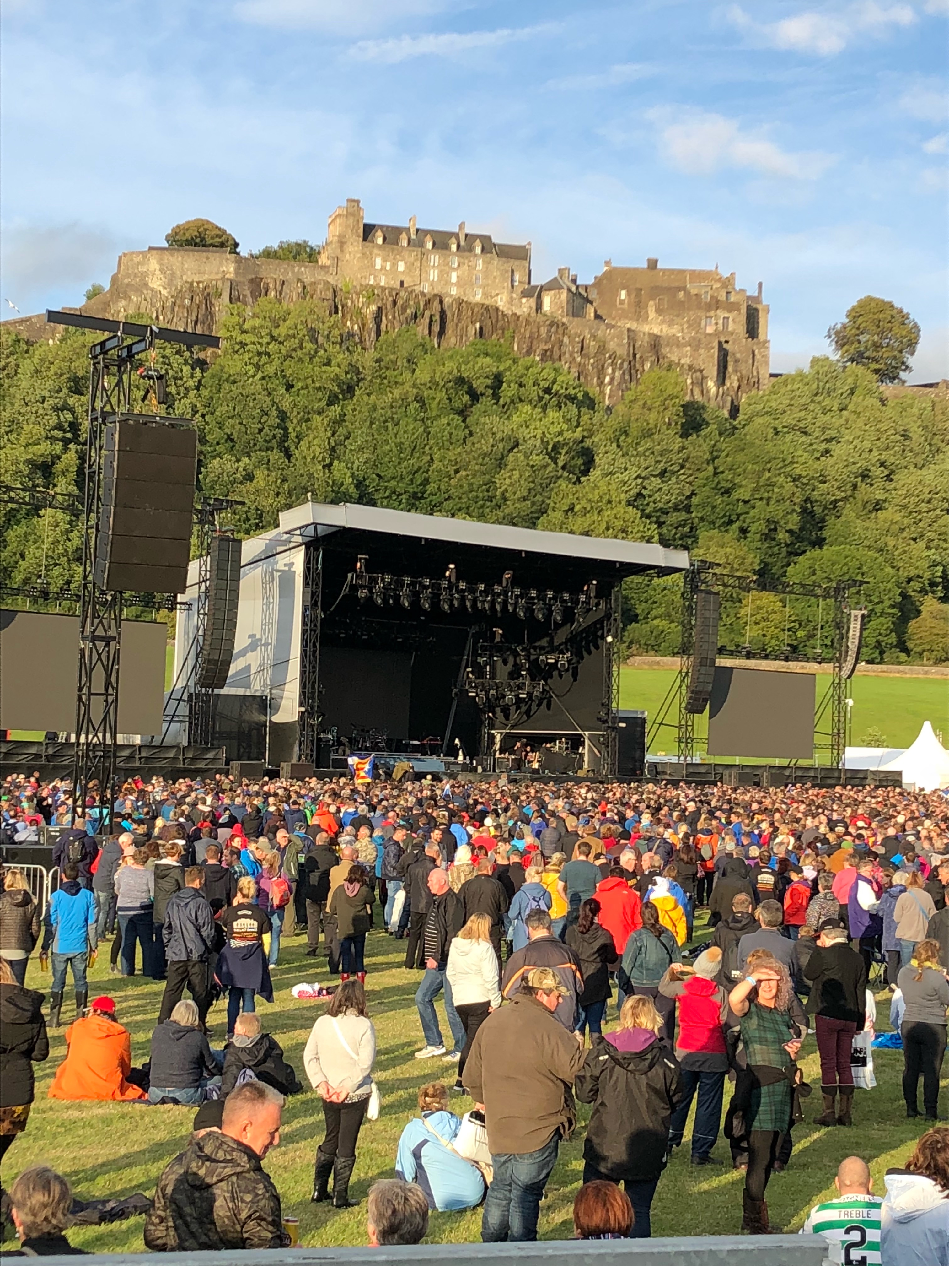A large group of people attending an outdoor concert