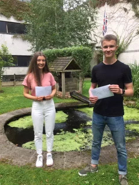 Former Head Boy and Girl Leah Wilosn and Ross Blackbourne celebrating their results with 2 A star grades and 1A each