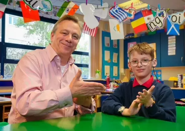 CSSC - Sign Language programme event photo (Mark Baker, CSSC and Cregagh Primary School pupil) engaging in sign