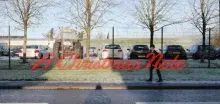 Photo with background of cars and a tractor with a school boy walking along a footpath with a message saying 'A Christmas note'