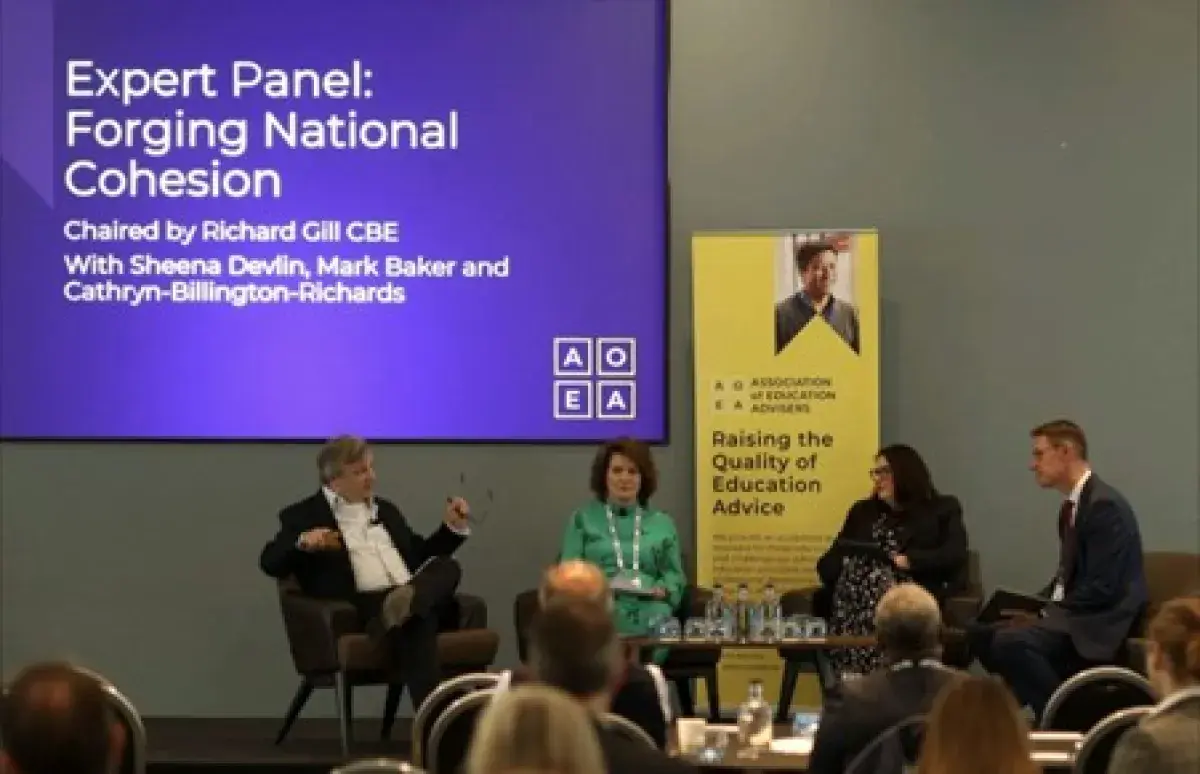 Mark Baker, Chief Executive, CSSC sitting with three other panel members. Expert Panel:Forging National Cohesion is written on a screen behind Mark Baker