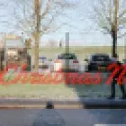Photo with background of cars and a tractor with a school boy walking along a footpath with a message saying 'A Christmas note'